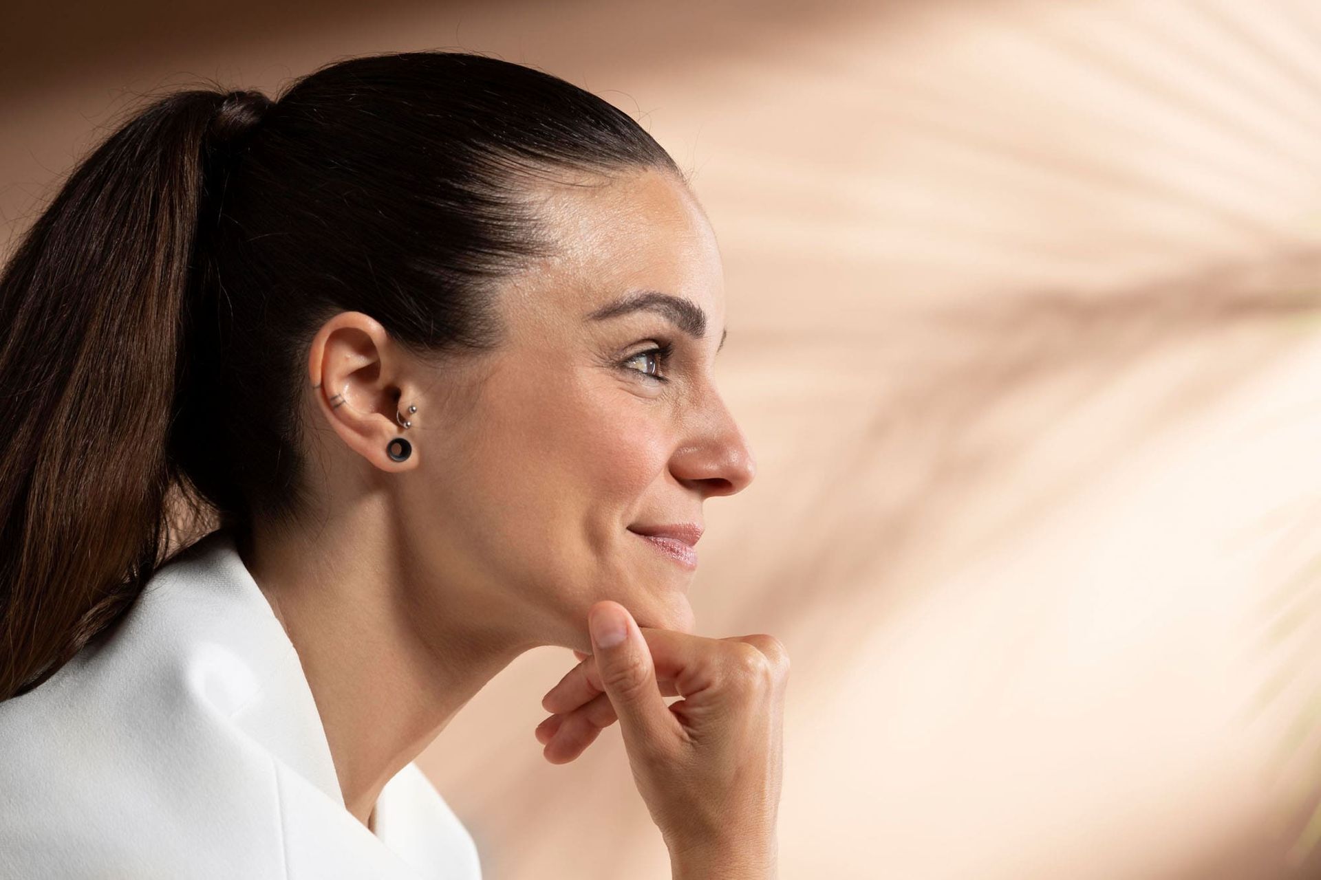 Stralende vrouw tijdens huidverbetering behandeling bij Glow Clinic in Nederland.